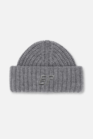 Grey chunky knit beanie with a folded cuff and embroidered monogram, shown from the front.