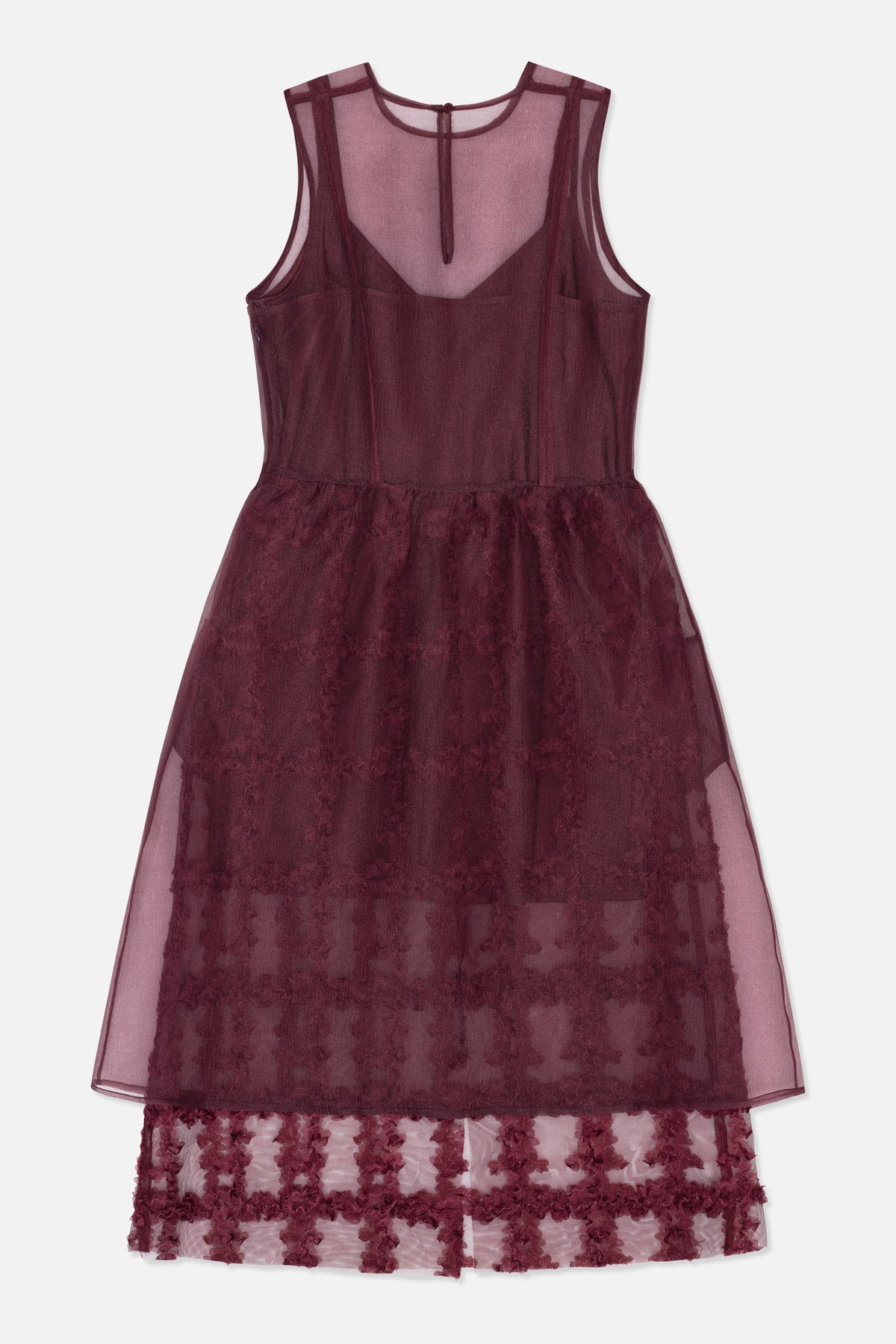 Back view of a plum sleeveless dress with a sheer A-line overlay, fitted bodice and floral-patterned lace hem.
