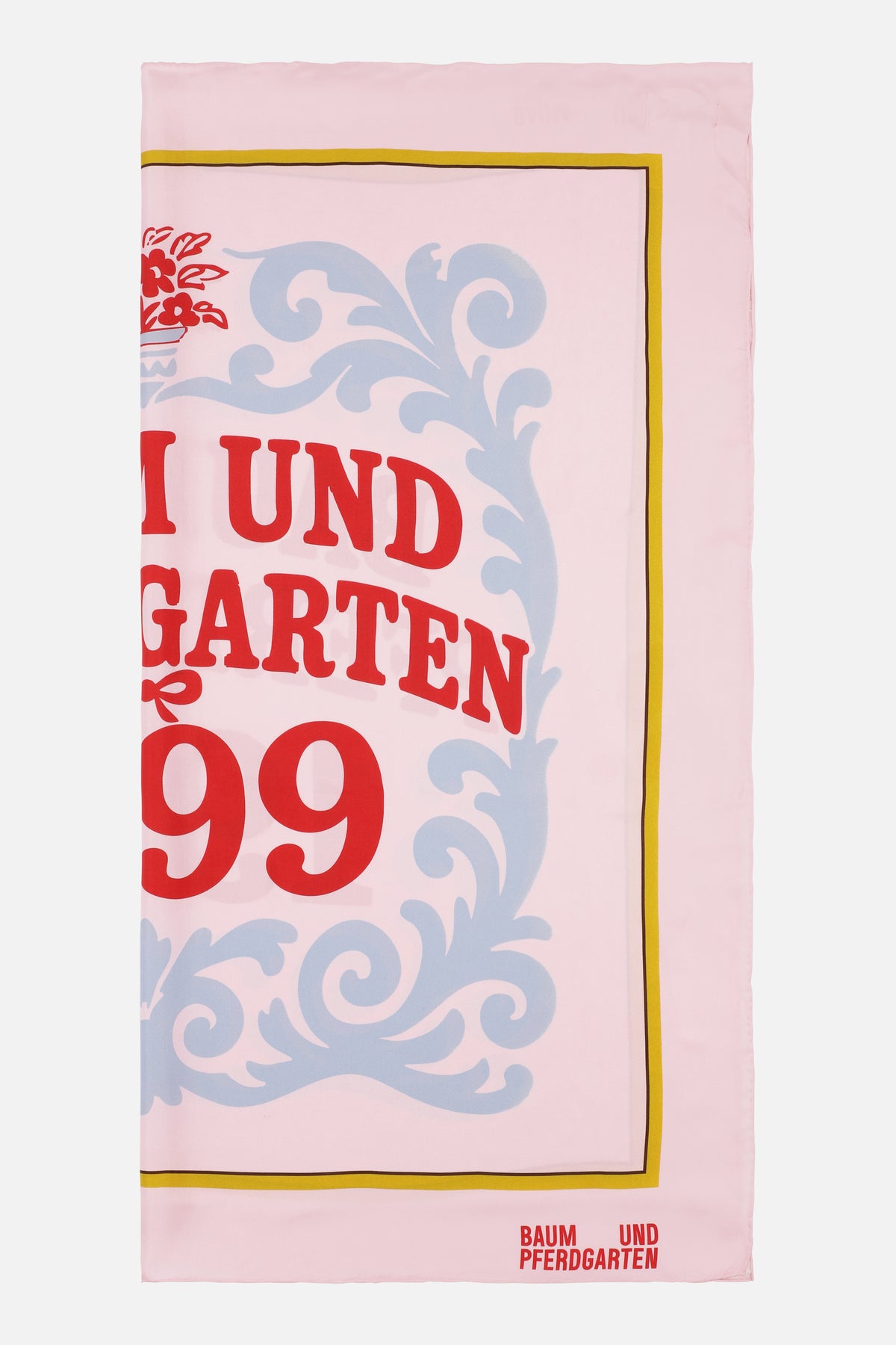 Pink rectangular scarf with large red lettering, pale blue ornamental scrollwork, a yellow and brown border, and a Baum und Pferdgarten logo.